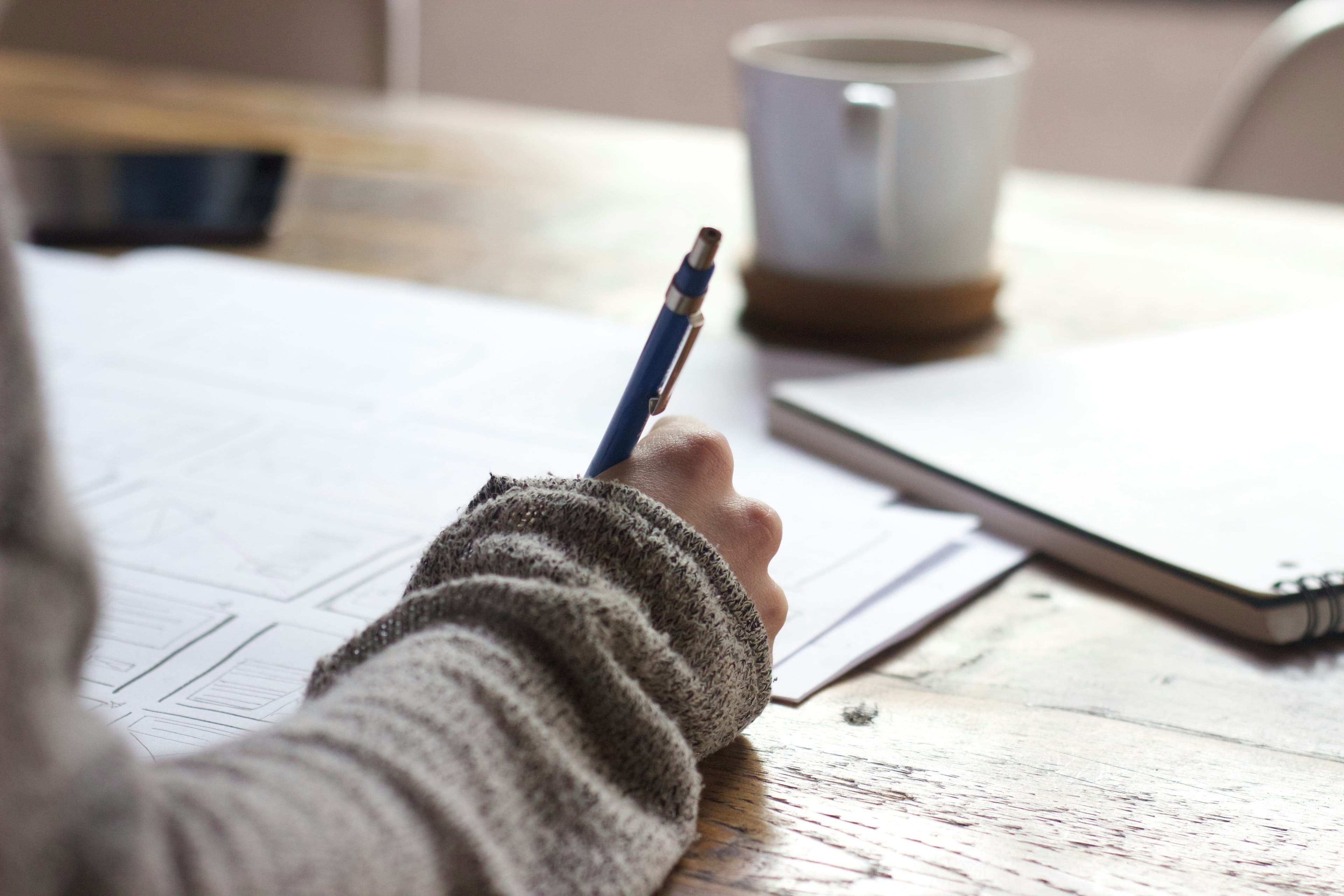 Woman signing a contract with a pen.